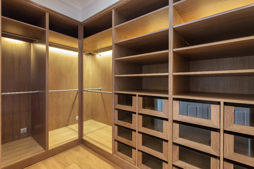 Custom-built reach-in closet with open shelves and hanging rods installed by Los Angeles Closet