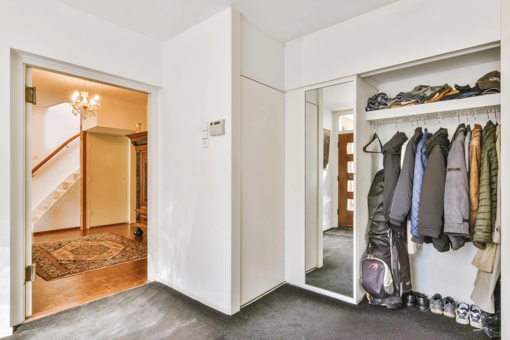 Contemporary living room with custom built-in entryway storage by Los Angeles Closet