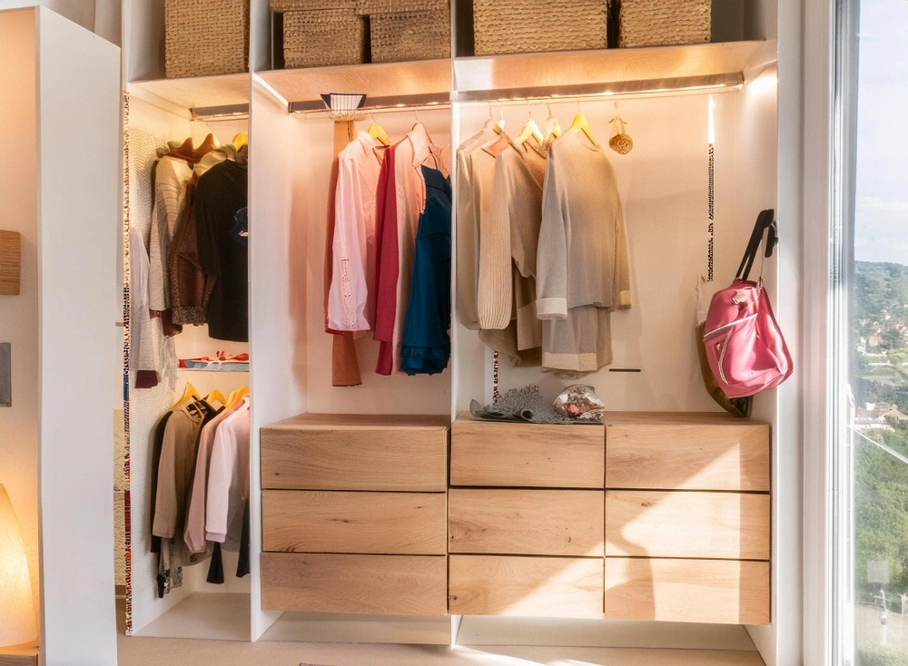 Stylish reach-in closet with sliding doors and organized storage by Los Angeles Closet