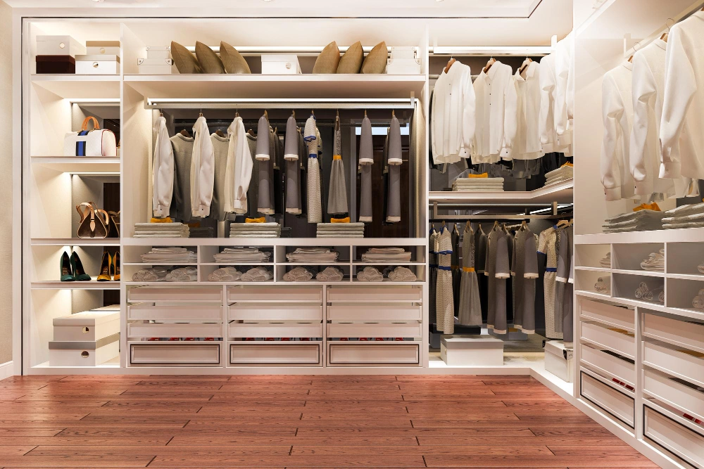 Modern walk-in closet with open shelving and wood flooring by Los Angeles Closet