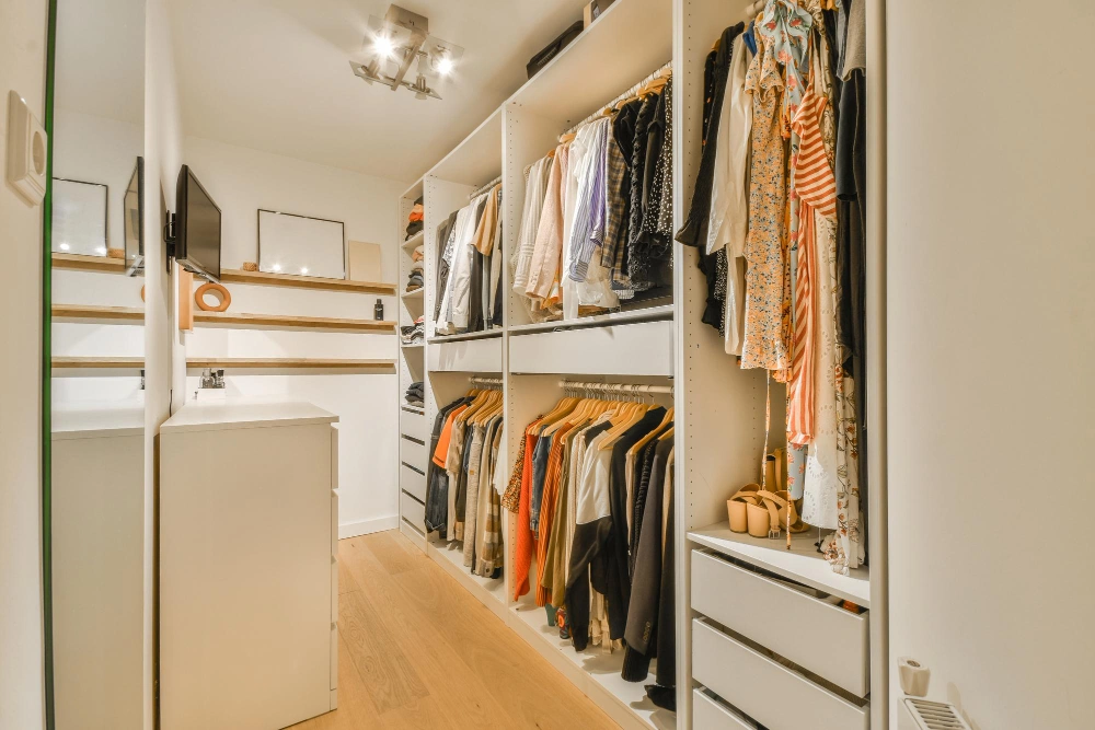 Modern walk-in closet design with open shelving and premium finishes by Los Angeles Closet